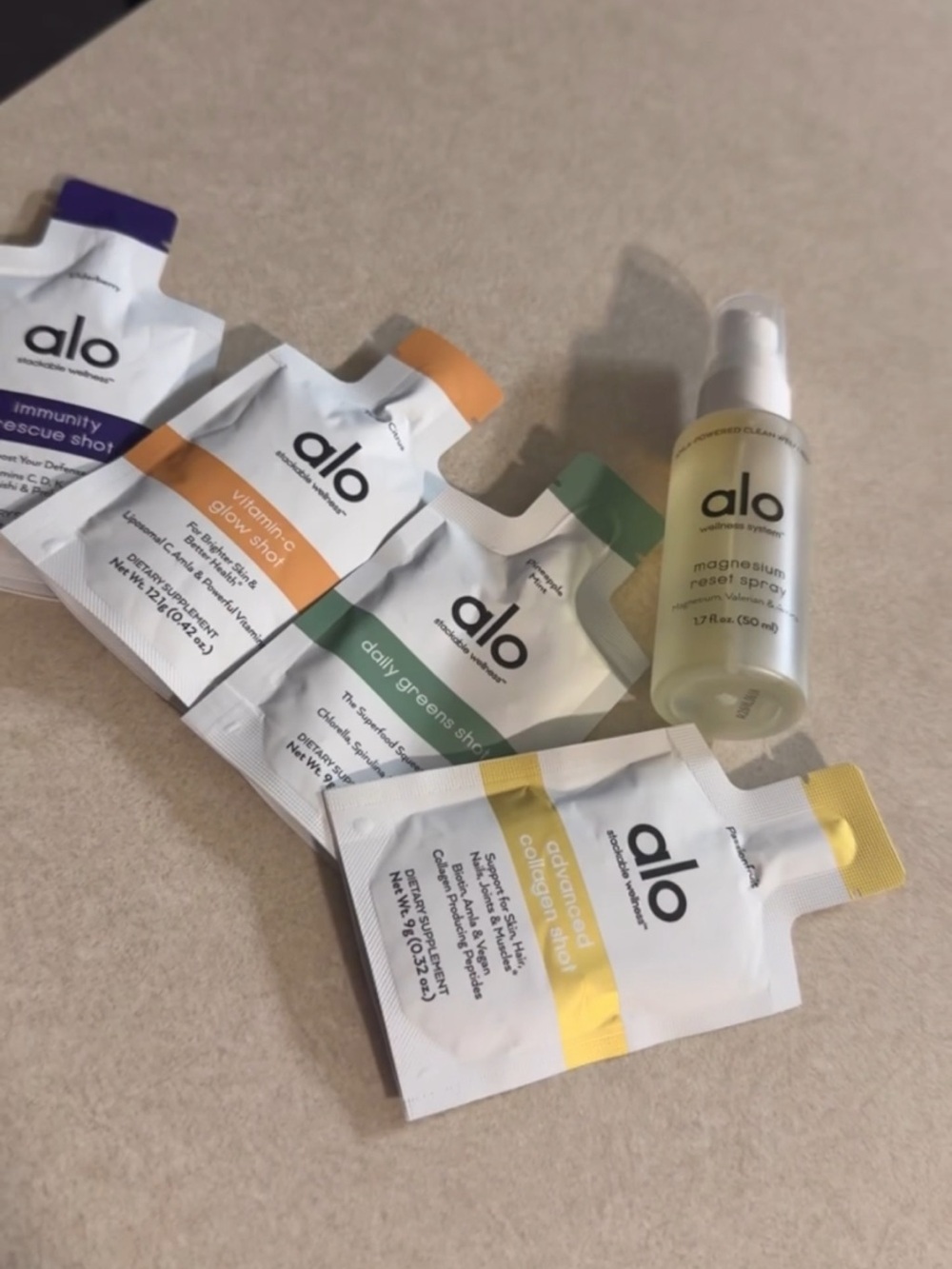 ALO Yoga skincare set with yellow-tinted magnesium spray and colorful sachets